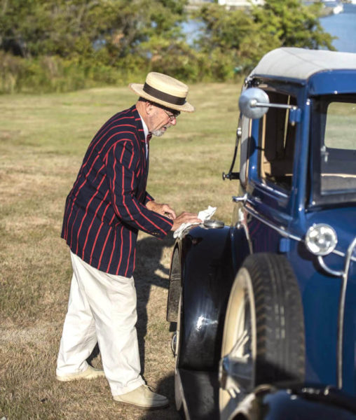 John Harris polishes a fender on his Model A Ford at The Lincoln Home's 95th birthday celebration in August 2022. Harris drove a group of friends to the event in the classic car, one of 27 in his automobile collection at that time. (LCN file photo)