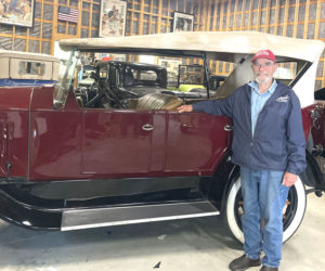 John Harris stands next to one of the classic automobiles in his collection in his garage in South Bristol. Harris shares his passion with the public through various cars shows, community events, and loans to appropriate museums. (Sherwood Olin photo)