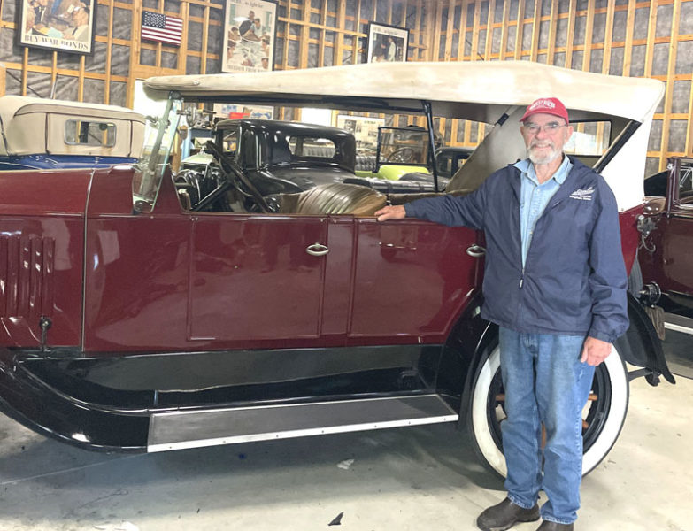 John Harris stands next to one of the classic automobiles in his collection in his garage in South Bristol. Harris shares his passion with the public through various cars shows, community events, and loans to appropriate museums. (Sherwood Olin photo)