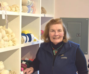 Kay Wegner, owner of Hillcrest House Fiber & Yarn in South Bristol, stands in front of shelves of yarn in her store on Monday, Nov. 17. Wegner has curated a collection of yarn from local farmers and artisans, along with specialty yarn from around the world. (Christina Wallace photo)
