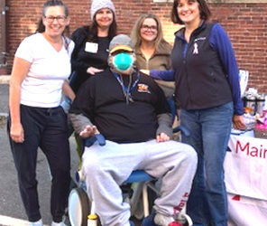 Dennis Levesque (center) enjoys a moment with members of the MaineHealth Lincoln Hospital team during Damariscotta Pumpkinfest. Levesque, an advanced stage cancer patient, was able to attend Pumpkinfest thanks to volunteers with the hospital and the Damariscotta Region Chamber of Commerce and Information Bureau. (Photo courtesy MaineHealth)