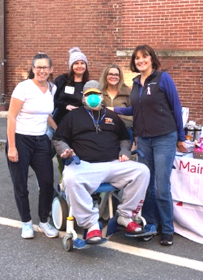 Dennis Levesque (center) enjoys a moment with members of the MaineHealth Lincoln Hospital team during Damariscotta Pumpkinfest. Levesque, an advanced stage cancer patient, was able to attend Pumpkinfest thanks to volunteers with the hospital and the Damariscotta Region Chamber of Commerce and Information Bureau. (Photo courtesy MaineHealth)