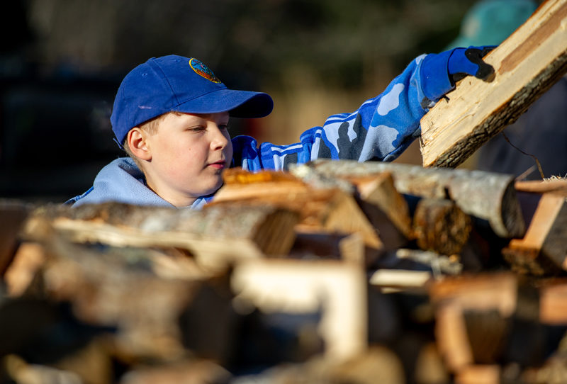 Nolan Pendleton, 11, stacks a piece of firewood at the Bristol-South Bristol Transfer Station on Saturday, Nov. 22. I wish I could split wood, said Nolan who is pursuing a Citizenship in the Community badge with the boy scouts. Operating machinery is limited to volunteers over the age of 18. (Bisi Cameron Yee photo)