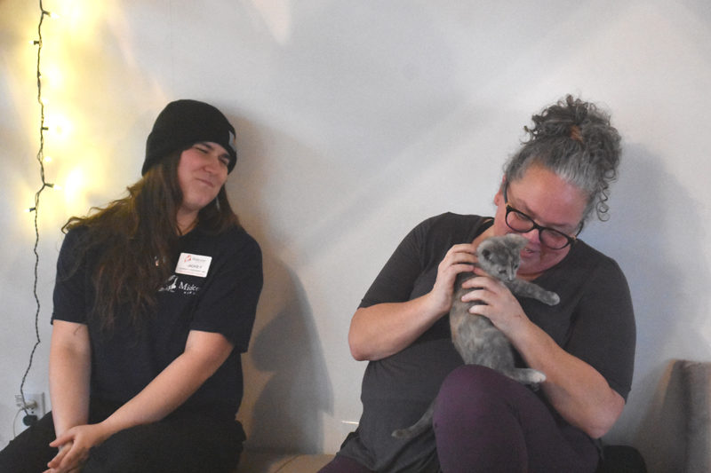 Midcoast Humane Community Engagement Manager Jackie Ferlito (left), and Jessica Amsden, steward of Live From Love Center, enjoy a kitten during the kitten yoga event in Bremen on Sunday, Nov. 30. The pair worked together to make the event possible. (Claire Taylor)