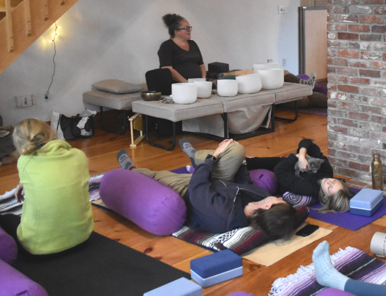 Participants stretch and snuggle kittens during kitten yoga at Live From Love Center in Bremen on Sunday, Nov. 30. The event was a collaboration between the studio and Midcoast Humane. (Claire Taylor photo)