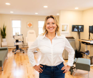 Dr. Seraphina Freund poses in front of her equipment at Intrinsic Health in Damariscotta. Freund offers a comprehensive approach utilizing the Gornstead method of chiropractics as well as regenerative therapy devices. (Photo courtesy Peter Logue)