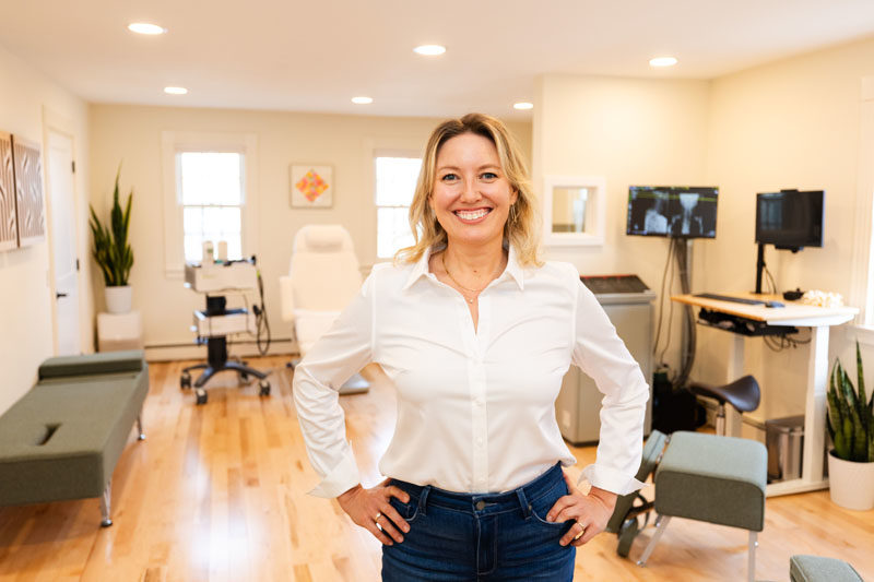 Dr. Seraphina Freund poses in front of her equipment at Intrinsic Health in Damariscotta. Freund offers a comprehensive approach utilizing the Gornstead method of chiropractics as well as regenerative therapy devices. (Photo courtesy Peter Logue)