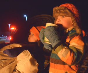 Toren Hammer (right), 5, enjoys some hot chocolate next to his little brother Aven Hammer, 1, in front of the bonfire at the Edgecomb Eddy School on Friday, Dec. 12. This was the second year the school hosted the Charlie Brown Christmas tree event. (Ali Juell photo)