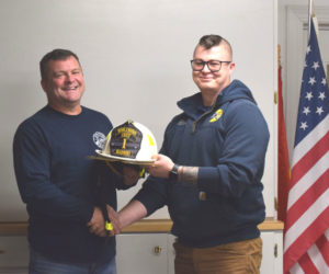 Aaron Bradbury (left) accepts the chief helmet from former Nobleboro Fire Chief Matthew Kilpatrick on Wednesday, Dec. 3. Bradbury, who served as interim chief from November 2023 to May 2024 and then as deputy chief since August of this year, takes the reins once again as Nobleboro fire chief. (Christina Wallace photo)