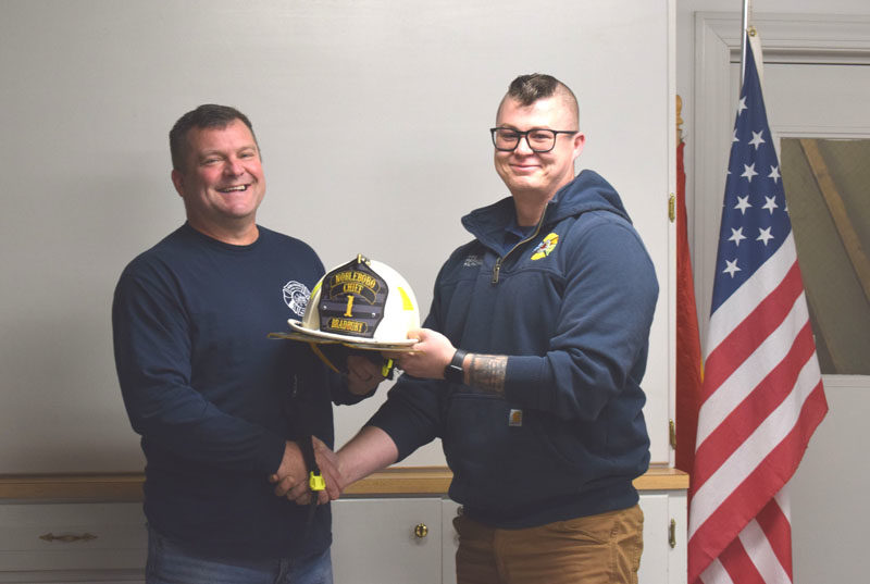 Aaron Bradbury (left) accepts the chief helmet from former Nobleboro Fire Chief Matthew Kilpatrick on Wednesday, Dec. 3. Bradbury, who served as interim chief from November 2023 to May 2024 and then as deputy chief since August of this year, takes the reins once again as Nobleboro fire chief. (Christina Wallace photo)