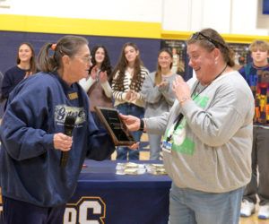 Kali Martin (right), a special education resource room teacher at Medomak Valley High School, accepts the Maine State Grange Educator of the Year Award from Sharon Morton on Monday, Dec. 22. Members of Willow Grange No. 366 in Jefferson nominated Martin for the award, which she was presented during the student of the month assembly. (Paula Roberts photo)