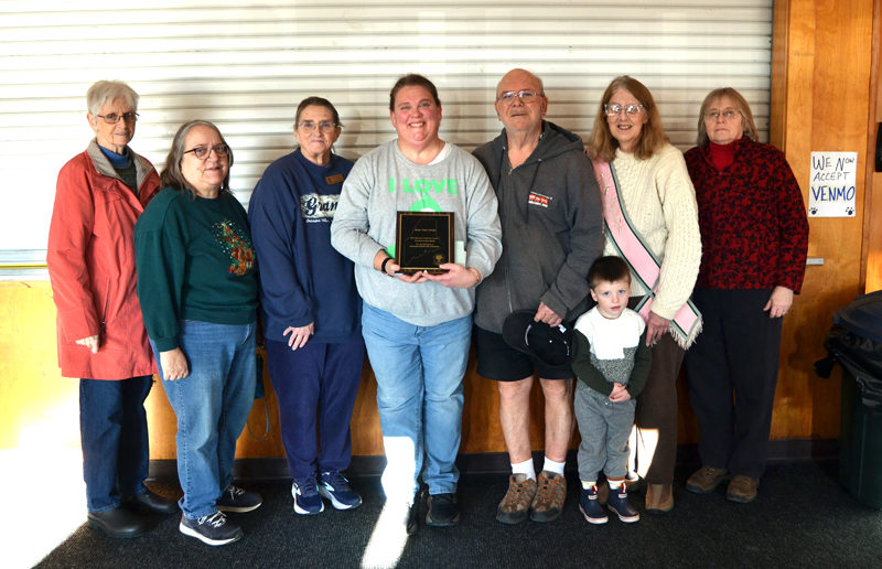Members of Willow Grange No. 366 in Jefferson flank Maine State Grange Educator of the Year Kali Martin after a presentation at Medomak Valley High School in Waldoboro on Monday, Dec. 22. The Willow Grange members nominated Martin for the award, which they surprised her with during a student of the month assembly. From left: Mary Jane McLoon, Deborah Willette, Sharon Morton, Kali Martin, Henry Morton, Knox Zaccadelli, Laurie McBurnie, and Paula Roberts. (Maia Zewert photo)