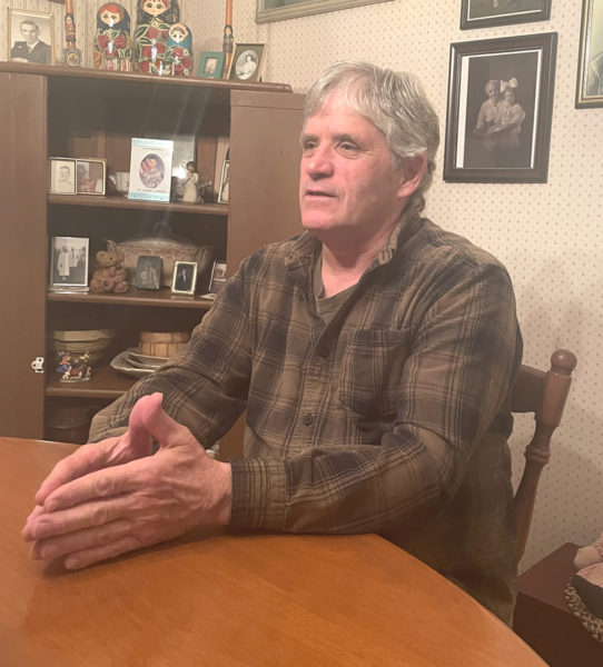 David Trahan makes a point during a conversation at his kitchen table in Waldoboro. A Waterville native, Trahan moved to Waldoboro at the request of his bride after the couple married in December 1983. (Sherwood Olin photo)