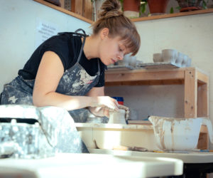 Aidan Fraser works on a piece for her Luster Hustler Ceramics business in her rented studio space in Portland in 2021. For Luster Hustler, Fraser specialized in producing human figurines that could double as a stand-alone sculpture or a functional item. (Photo courtesy Mailee Osten-Tan)