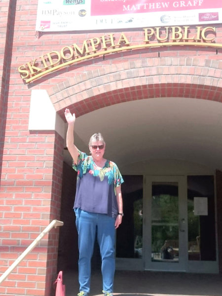 Pam Gormley waves from the front steps of the Skidompha Public Library in Damariscotta. Gormley, the library's former executive director, died Wednesday, Jan. 7 following a lengthy period of declining health. (Courtesy photo)
