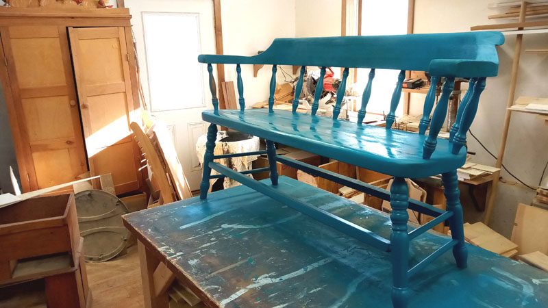 A fresh coat of paint dries on a bench Ed Porter restored with a group of Mobius Inc. clients he works with. The group has have partnered with Stepping Stone Thrift Store to restore furniture being sold to help generate more revenue for Stepping Stone Housing Inc. and provide camaraderie among the group. (Photo courtesy Ed Porter)