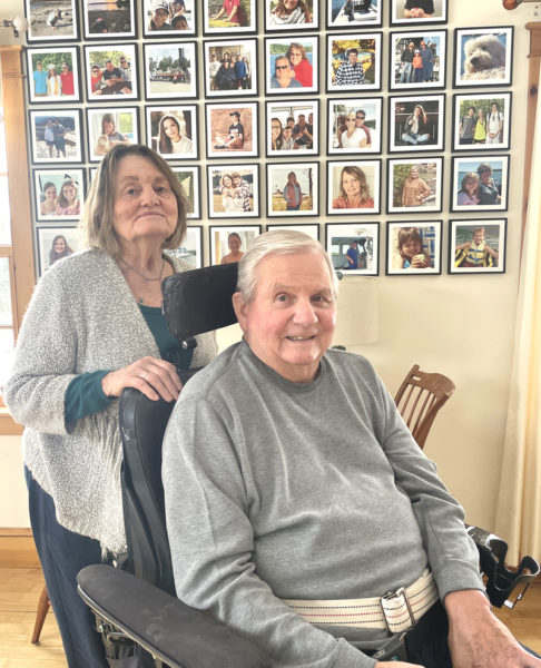 Rosie and Paul Kelsey Sr. pose in front of photo array of family members in the living room of their Walpole home. The couple met as teenagers while roller skating in Pemaquid and married in 1967, just after Paul Kelsey returned from serving in the Army in Vietnam. (Sherwood Olin photo)