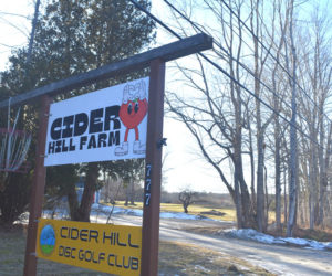 A disc golf basket hangs from the sign for Cider Hill Farm Taproom and Disc Golf Club, at 785 Main St. in Waldoboro, on Friday, Jan. 16. (Claire Taylor photo)