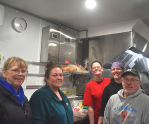 Kendall Delano Jr. and members of his kitchen crew are all smiles in the Delano Seafood Shack kitchen on Friday, Jan. 16. Prior moving into the newly constructed building, Delano and his crew ran the business from a 28-foot long trailer, year-round. From left: Angela Robinson, Crystal Wellman, Glendora Lash, Jessica Murphy, and Delano. (Claire Taylor photo)