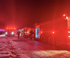 Fire trucks line the road at Brookside Mobile Home Park in Waldoboro during a structure fire on Tuesday, Dec. 30. (Christina Wallace photo)