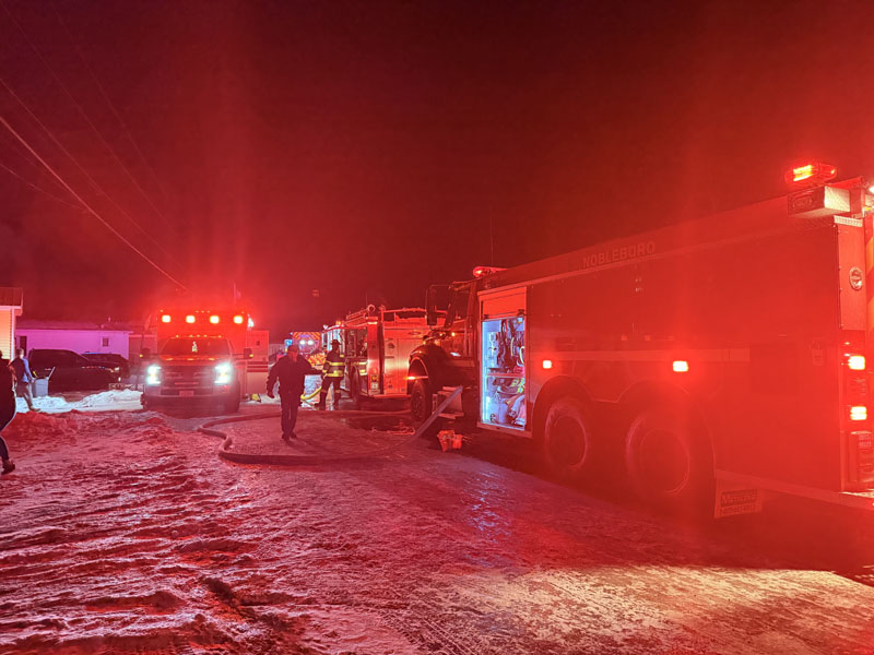 Fire trucks line the road at Brookside Mobile Home Park in Waldoboro during a structure fire on Tuesday, Dec. 30. (Christina Wallace photo)