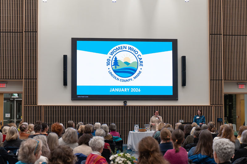 Kate Elmes (left) and Leah Bauer capture an audience of 150 local women during a meeting of 100+ Women Who Care Lincoln County at Bigelow Laboratory for Ocean Science in Boothbay on Jan. 6. (Photo courtesy Melissa Keyser)