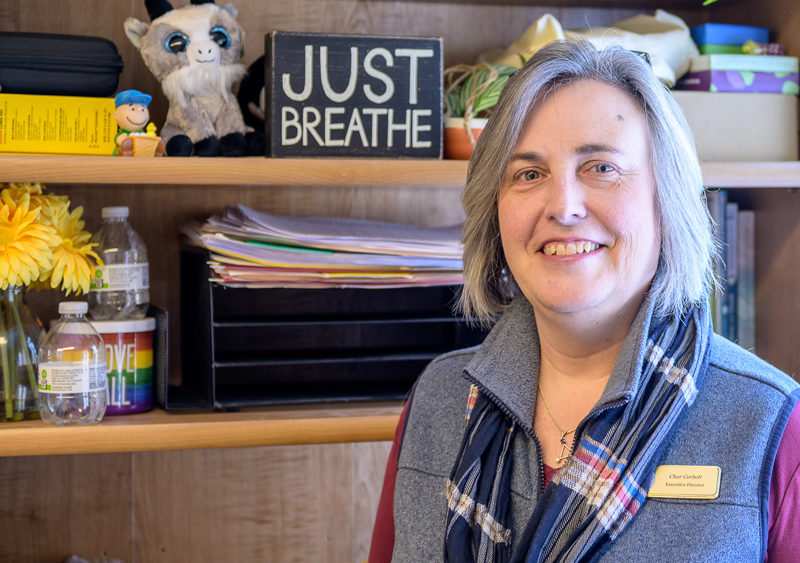 Char Corbett stands for a photo by a bookcase in her office at Healthy Kids in Newcastle on Feb. 9. I have reminders (for) when things start getting to me, she said. I just remember to breathe. (Bisi Cameron Yee photo)