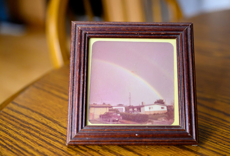 A photo of her childhood home in Albaquerque, complete with double rainbow, occupies a small wooden frame at Char Corbetts home in Bremen on Jan. 9. Seeing that rainbow at the age of 5 instilled in me ever since the power of prayer and the presence of God, Corbett said. (Bisi Cameron Yee photo)