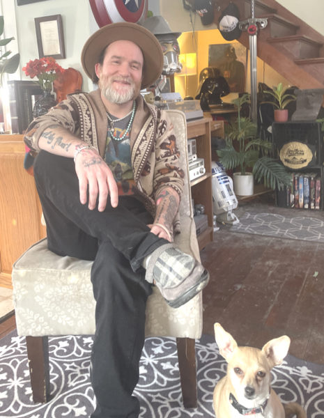 Supervised by his chihuahua, Sarah, Papa Tim Goad relaxes at home in Wiscasset. Starting from scratch in 2015, Goad has built a music career through luck and hard work. This year he is hoping to plays more shows around New England. (Sherwood Olin photo)