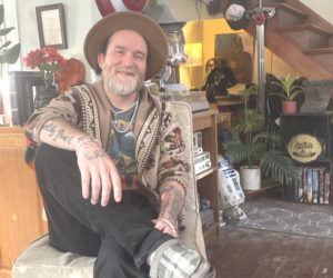 Supervised by his chihuahua, Sarah, Papa Tim Goad relaxes at home in Wiscasset. Starting from scratch in 2015, Goad has built a music career through luck and hard work. This year he is hoping to plays more shows around New England. (Sherwood Olin photo)