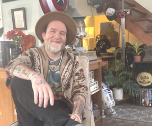 Supervised by his chihuahua, Sarah, Papa Tim Goad relaxes at home in Wiscasset. Starting from scratch in 2015, Goad has built a music career through luck and hard work. This year he is hoping to plays more shows around New England. (Sherwood Olin photo)