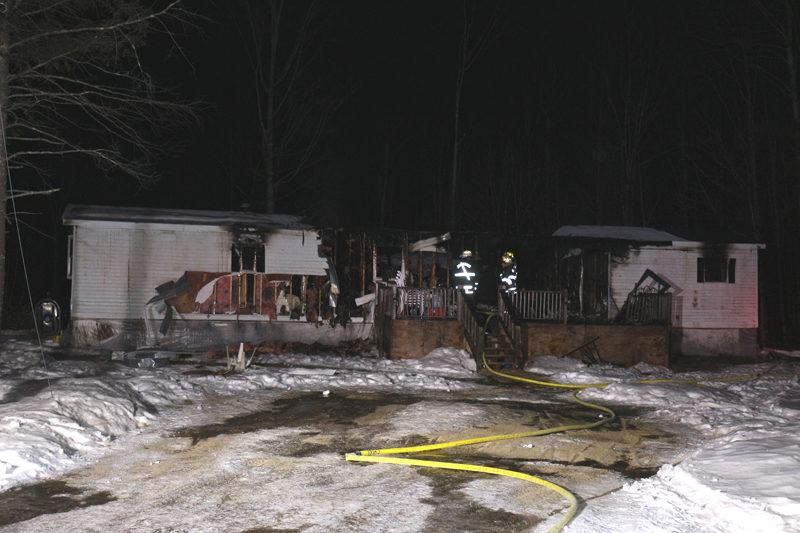 Firefighters stand on the porch of a destroyed house at 801 North Nobleboro Road in Waldoboro. The home was lost to fire on Friday, Feb. 20. The Waldoboro Fire Department and mutual aid towns were dispatched slightly after 2:30 a.m. (Courtesy photo)