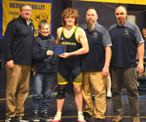 Grady Pease is presented with an award for his 200th career win during the Class B South regional championships on Saturday, Feb. 7 in Waldoboro. Pease, a senior at Medomak Valley High School, is the first Panther to ever reach the milestone. From left: Medomak Valley Athletic Director Matt Lash, Principal Linda Pease, Grady Pease, assistant coach Jason Pease, and head coach Jed Harris. (Mic LeBel photo)