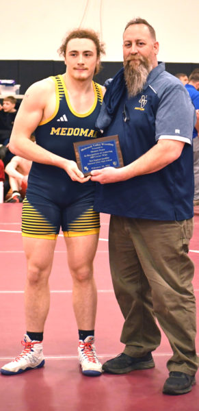 Shamus Pease celebrates his 200th career win with his father Jason Pease during the New England qualifier tournament on Friday, Feb. 20 in Auburn. (Mic LeBel photo)