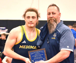 Shamus Pease celebrates his 200th career win with his father Jason Pease during the New England qualifier tournament on Friday, Feb. 20 in Auburn. (Mic LeBel photo)