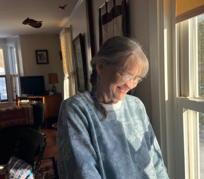 Pam Trahan at home, surrounded by photos, furniture, and mementos from her family and her husband David.