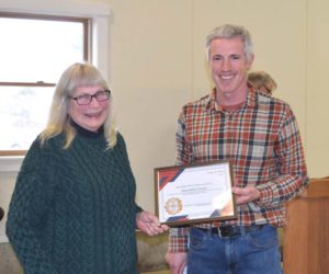 Alna First Selectperson Nick Johnston presents Mary Fossel with Alnas 2026 Spirit of America Award at the conclusion of Alnas annual town meeting on Saturday, March 21. Accepting the community service award, Fossel urged her fellow residents to get involved in their community. I keep volunteering, and I make a plug for everyone to volunteer, Fossel said. (Sherwood Olin photo)