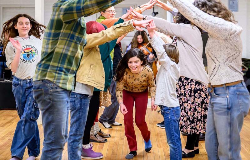 Maari Glendenning (center) goes through the bridge while her dance partner Grace Walker (far left) takes the outside during a contra dance at the Damariscotta Baptist Church on Jan. 9. The series of community contra dances in Damariscotta and New Harbor are welcoming of all ages and abilities. (Bisi Cameron Yee photo)