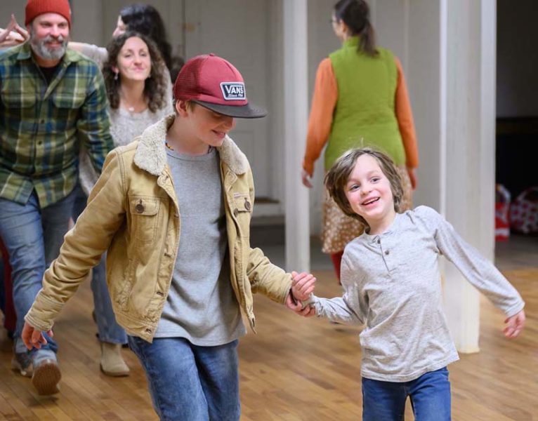 Caleb Rudy (front left), 11, dances down the center with younger brother Arlo, 6 during a contra dance at the Damariscotta Baptist Church on Jan. 9. The boys parents smile as they dance behind them. (Bisi Cameron Yee photo)
