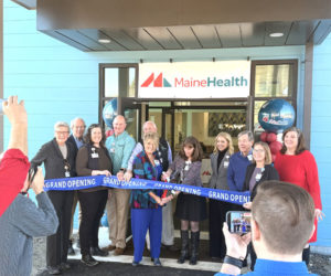 MaineHealth Lincoln Hosiptal President Cindy Wade and Senior Manager of Operations Stacey Miller cut a ribbon outside of the new primary care facility in Waldoboro while flanked by representatives from the hospital and the town on Tuesday, March 10. From left: Marva Nesbit, Bruce Garren, Reven Oliver, Brooks Betts, Mike Gagnon, Cindy Wade, Stacey Miller, Denise Needham, John Dickens, Audrey Hanna, and Julie Keizer. (Christina Brown photo)