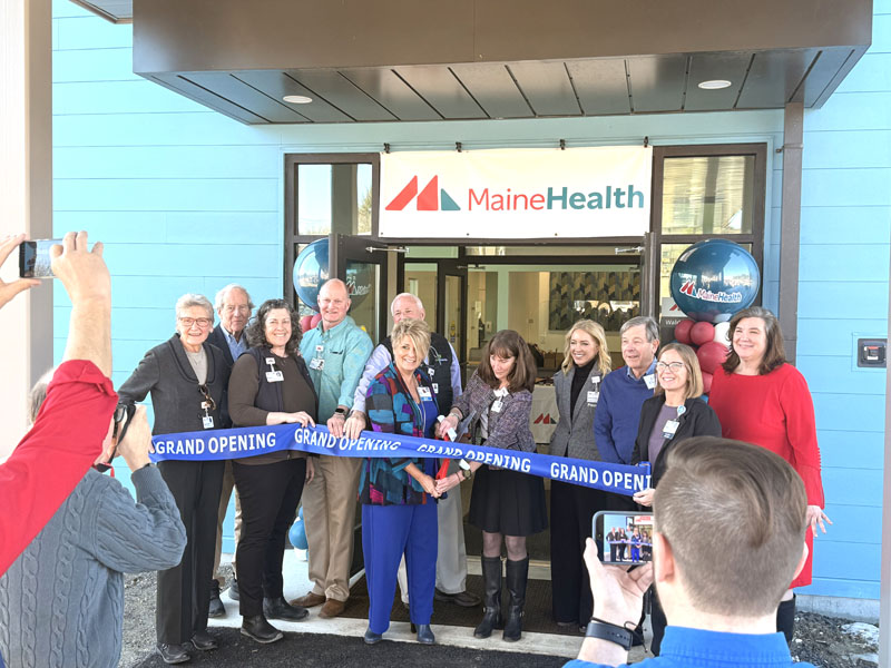 MaineHealth Lincoln Hosiptal President Cindy Wade and Senior Manager of Operations Stacey Miller cut a ribbon outside of the new primary care facility in Waldoboro while flanked by representatives from the hospital and the town on Tuesday, March 10. From left: Marva Nesbit, Bruce Garren, Reven Oliver, Brooks Betts, Mike Gagnon, Cindy Wade, Stacey Miller, Denise Needham, John Dickens, Audrey Hanna, and Julie Keizer. (Christina Brown photo)
