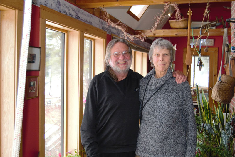 David Tracy Moskovitz (left) and Bambi Jones (right) smile in their 2,550-square-foot home, built out of wood harvested from their property shortly after they moved to Whitefield in 1978. The two now plan on gifting or selling their 1,200 acres of land, known as Hidden Valley Farm and Forest, to the best fitting nonprofit organization that will continue to be stewards of the land they have worked on for almost 50 years. (Emily Bracher photo)