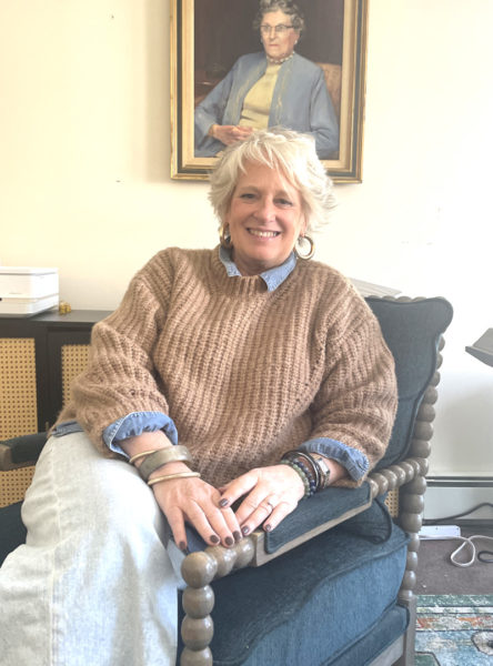 Lorrie Winslow, chief executive officer of The Lincoln Home, sits beneath a portrait of Lillian Albie Nash, one of the organizations founders, in her Newcastle office. A Waterboro native, Winslow knew little about the area before moving to Lincoln County with her husband in 2020. (Sherwood Olin photo)