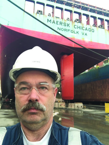 Captain Scott Pendleton takes a self image with the final ship in his career, Maersk Chicago, in the background. (Courtesy photo)