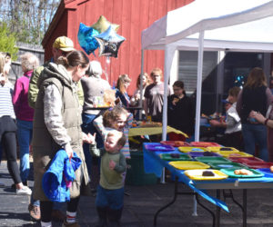 Current and former students and their families gather at Coastal Kids Preschool in Damariscotta to celebrate the preschools 30th birthday on Saturday, April 4. The event featured fence painting to create an art installation at the preschool, live music, food, and a trip down memory lane with photos of all the graduating classes lining the walls. (Christina Brown photo)