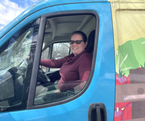 Healthy Lincoln County Community Routes Project Coordinator Samantha Mehlhorn sits in the driver seat of Lulu the Lunch Wagon. Primarily used for Healthy Lincoln Countys summer meals distribution program, Lulu has been pressed into double duty to do deliveries for the Community Routes program. (Sherwood Olin photo)