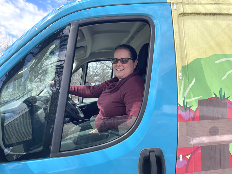 Healthy Lincoln County Community Routes Project Coordinator Samantha Mehlhorn sits in the driver seat of Lulu the Lunch Wagon. Primarily used for Healthy Lincoln Countys summer meals distribution program, Lulu has been pressed into double duty to do deliveries for the Community Routes program. (Sherwood Olin photo)