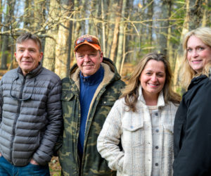 From left: Sam Caton, Tom Caton, Loretta Morse Leighton, and Julie Ketelhut pose for a photo in Wiscasset on Monday, April 20. Sam and Tom Caton initiated the cleanup of a vernal pond by Shaws Supermarket on Bath Road. Leighton and Ketelhut are the administrators of the Wicked Good Wiscasset page, which helped source additional volunteers. (Bisi Cameron Yee photo)