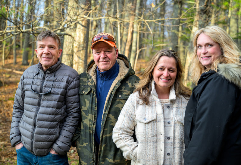 From left: Sam Caton, Tom Caton, Loretta Morse Leighton, and Julie Ketelhut pose for a photo in Wiscasset on Monday, April 20. Sam and Tom Caton initiated the cleanup of a vernal pond by Shaws Supermarket on Bath Road. Leighton and Ketelhut are the administrators of the Wicked Good Wiscasset page, which helped source additional volunteers. (Bisi Cameron Yee photo)