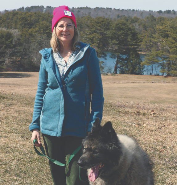 Property owner and donor Eleanor Kinney with her dog Ollie. Kinney spent years acquiring the land with the intent of putting it in conservation (Photo courtesy Kris Christine)